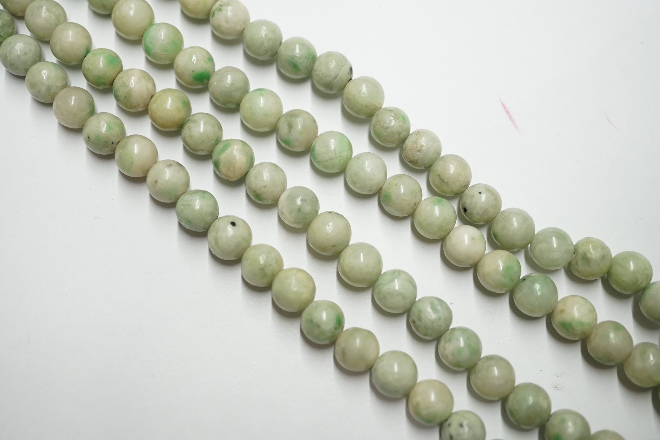 A double strand jade bead choker necklace, with cabochon jade set yellow metal clasp, 38cm. Condition - poor to fair